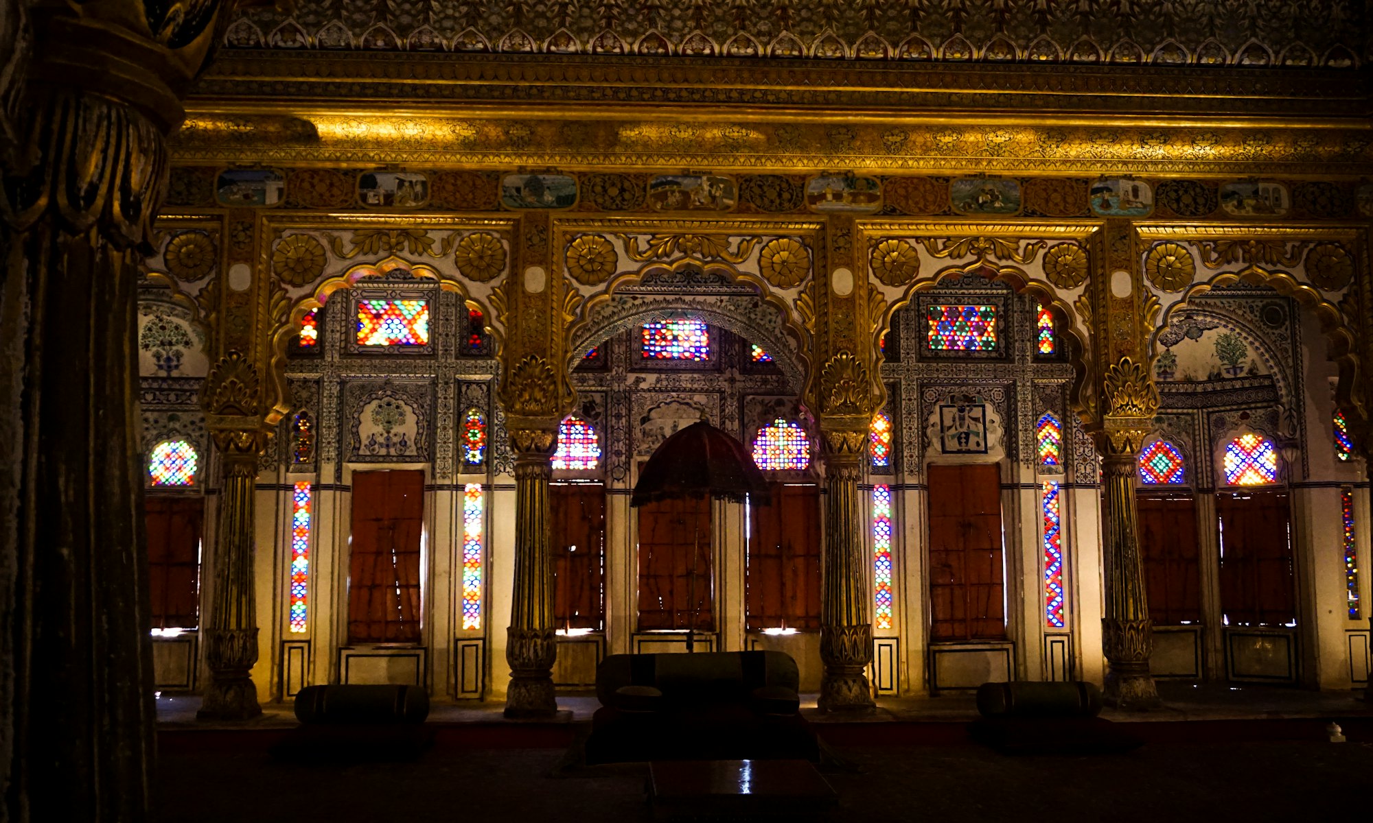 A gilded palace hall with stained glass windows