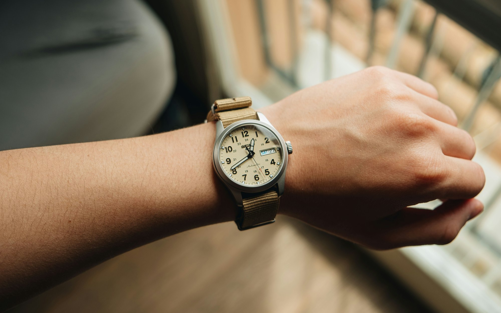 A watch on a wrist in warm morning light